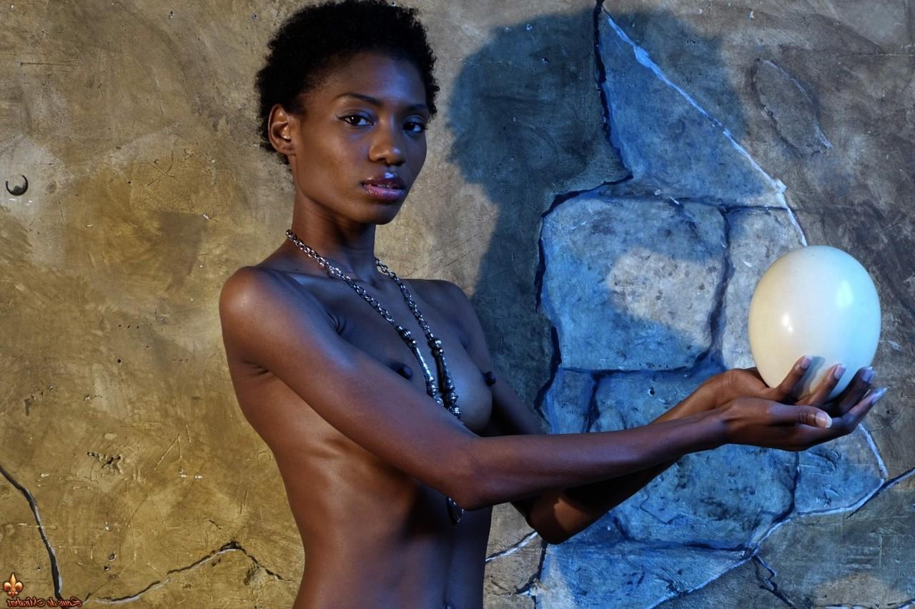 15P Dark skinned girl Jess holds a large egg while modeling butt naked