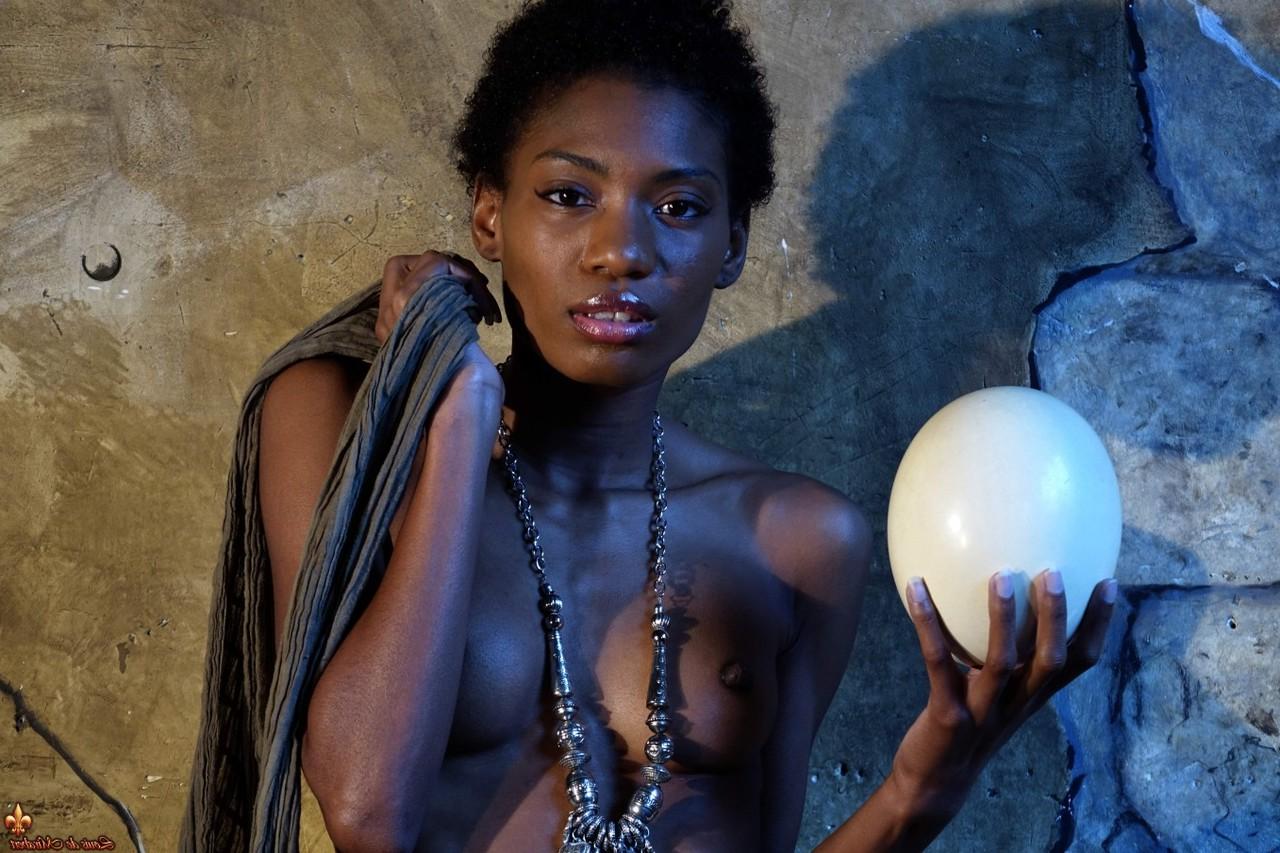 15P Dark skinned girl Jess holds a large egg while modeling butt naked