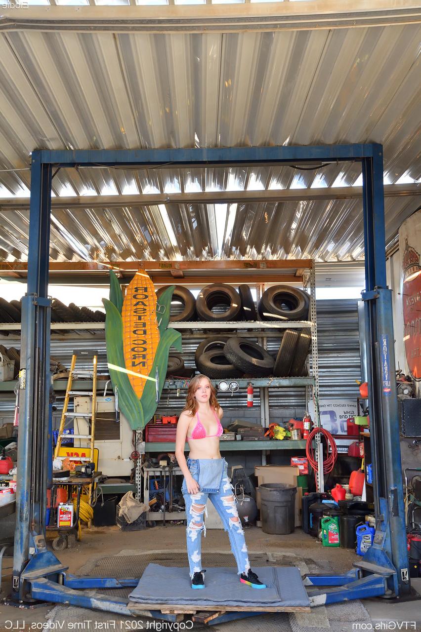 20P Shameless babe Elodie strips in the garage and toys her sweet pussy