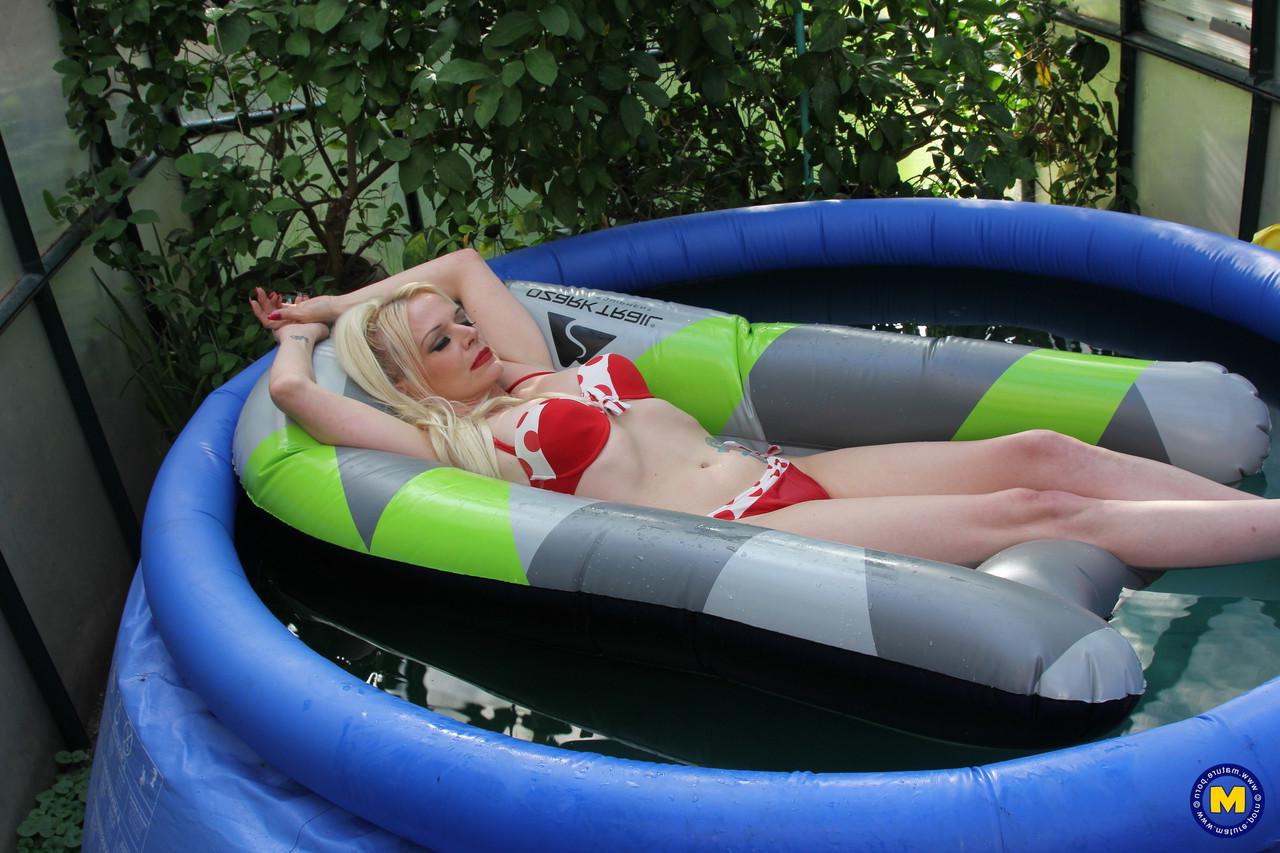 20P Mature European Veronica Moore uncovers her big tits in a wading pool