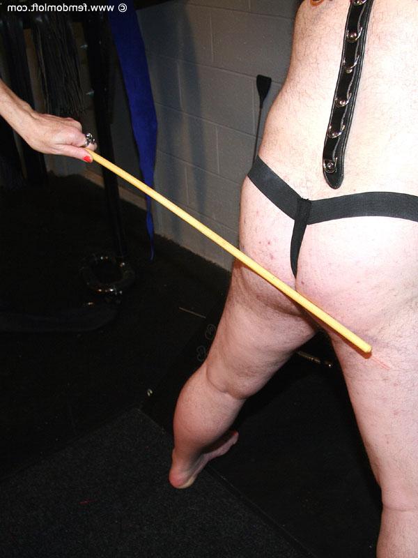 16P Mature lady dominates a submissive man up against a St Andrews Cross