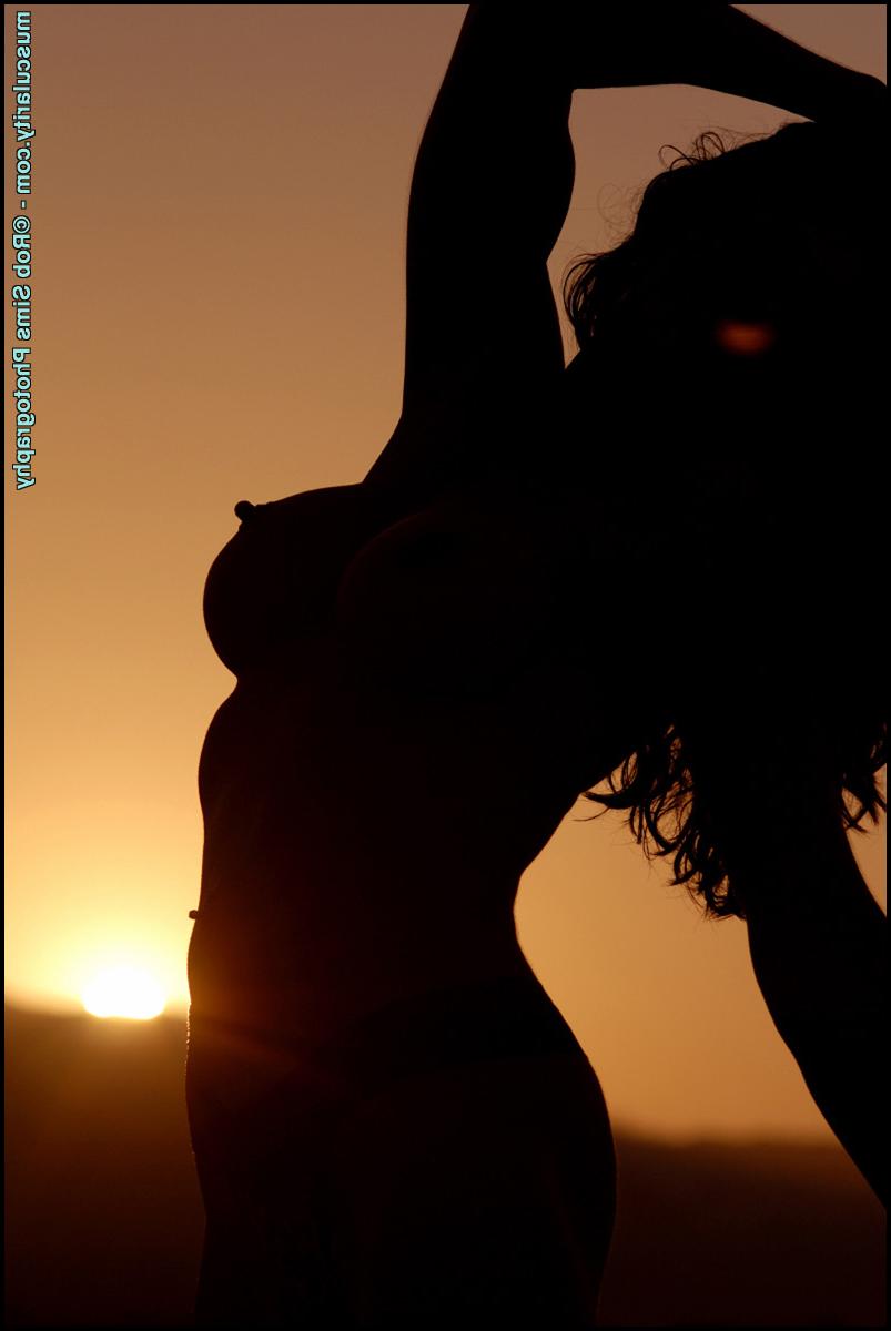 15P Bodybuilder Tara Caden models on a beach in her swimwear during solo action