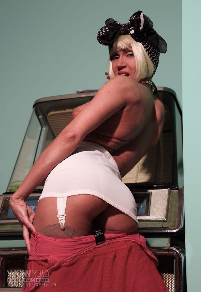 15P Blonde MILF goes topless in a retro girdle and vintage nylons