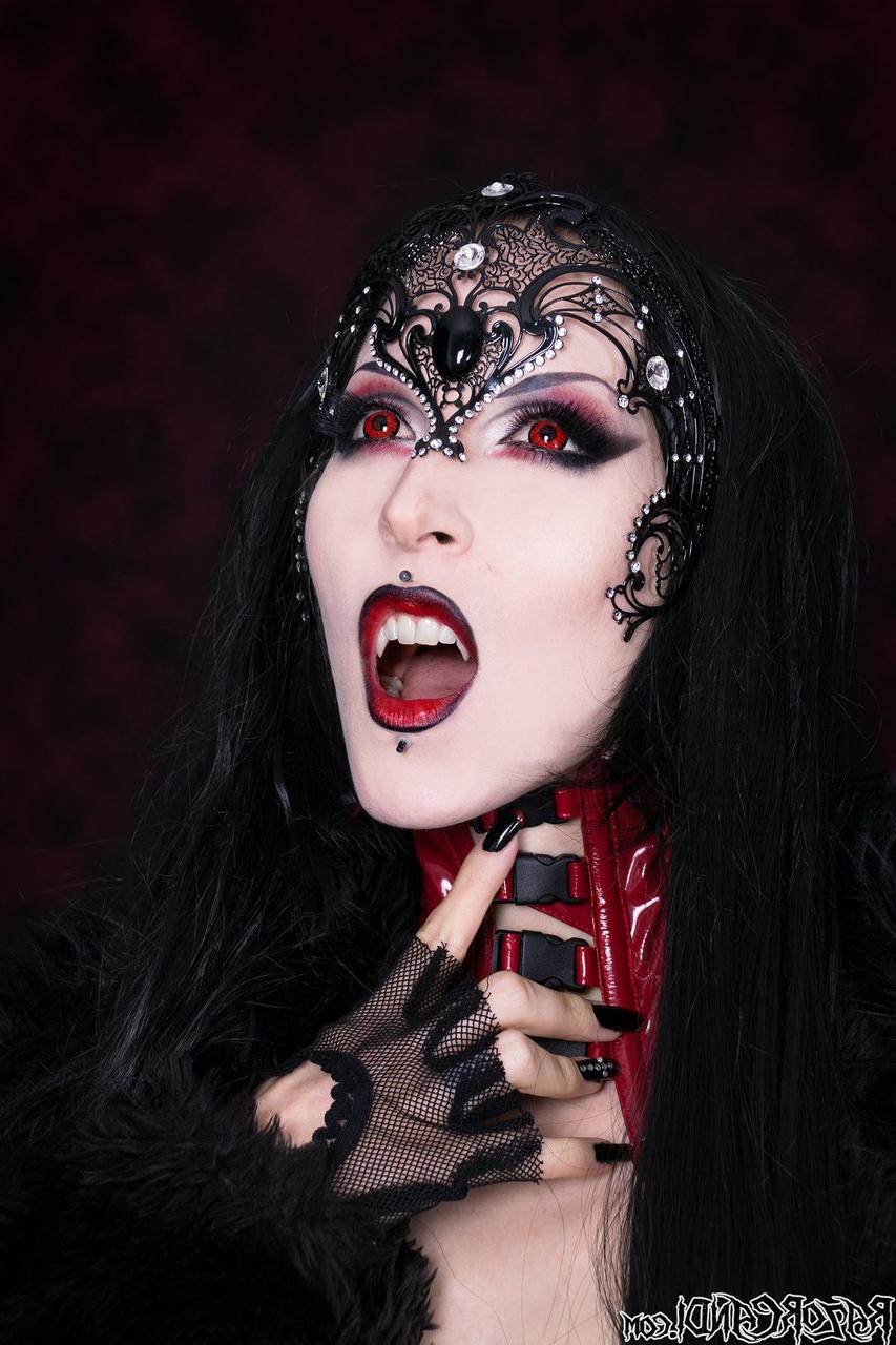 15P Goth girl Razor Candi works her tits and twat clear of see thru onesie
