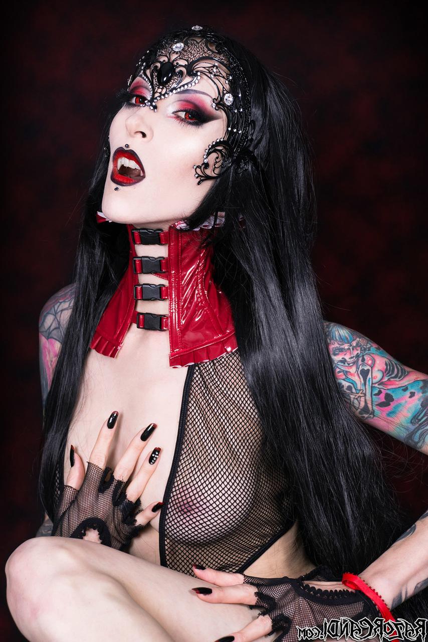 15P Goth girl Razor Candi works her tits and twat clear of see thru onesie