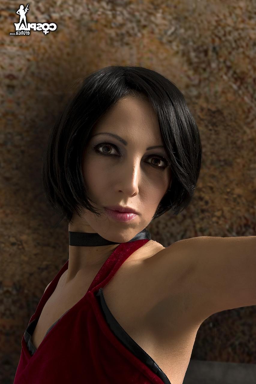 12P Alluring brunette cosplayer wields a pistol while exposing her tits and pussy