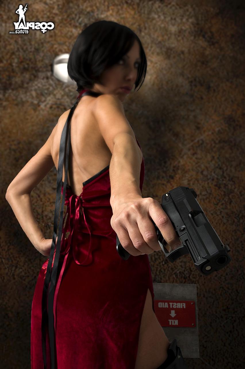 12P Alluring brunette cosplayer wields a pistol while exposing her tits and pussy