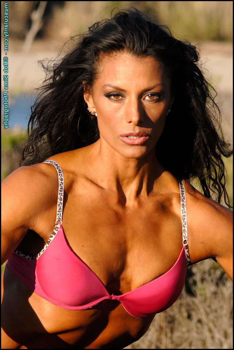 15P Brunette bodybuilder Deidre Pagnanelli poses on burnt stump in a field