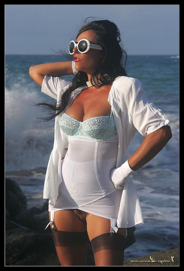 15P Dark haired MILF frees her tits from a girdle at the ocean in retro nylons