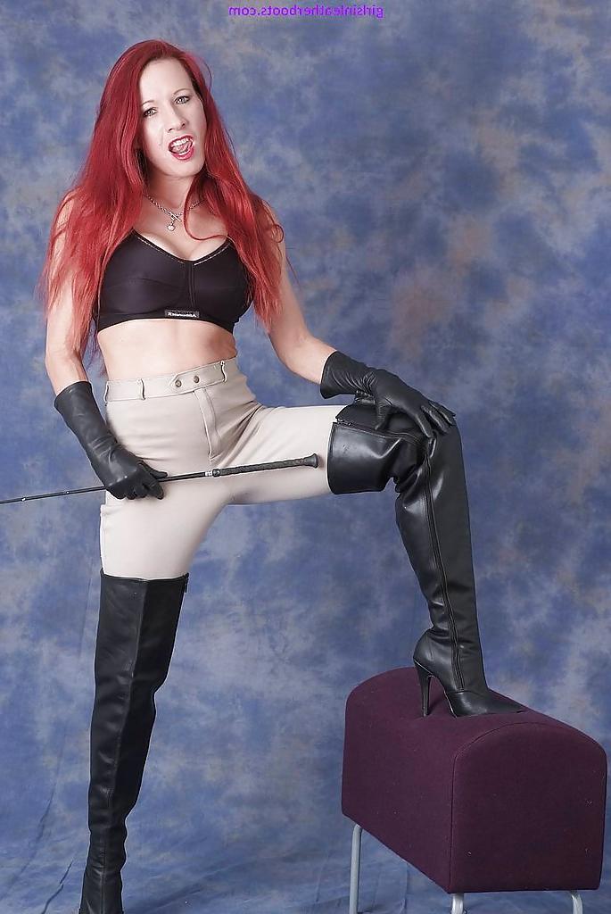 16P Redhead chick in riding pants and poses in leather boots and gloves