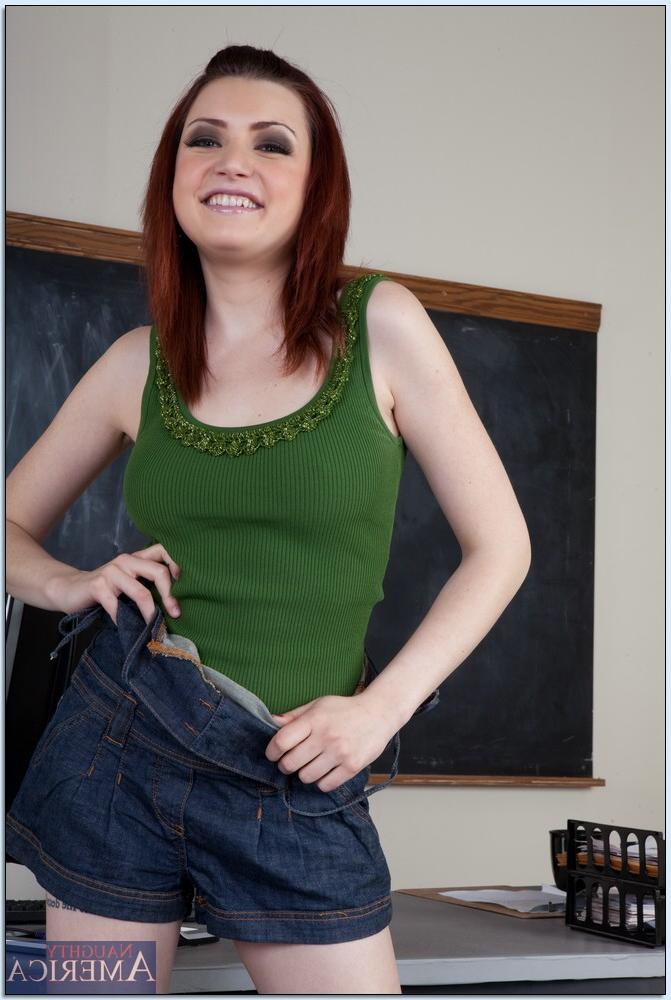20P Redheaded coed Madison Fox strips in the classroom & fingers her pussy