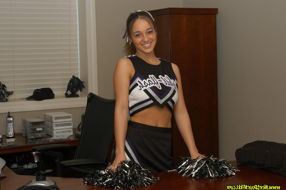 12P Brunette cheerleader Nikki Sims takes off her uniform top in a teasing manner