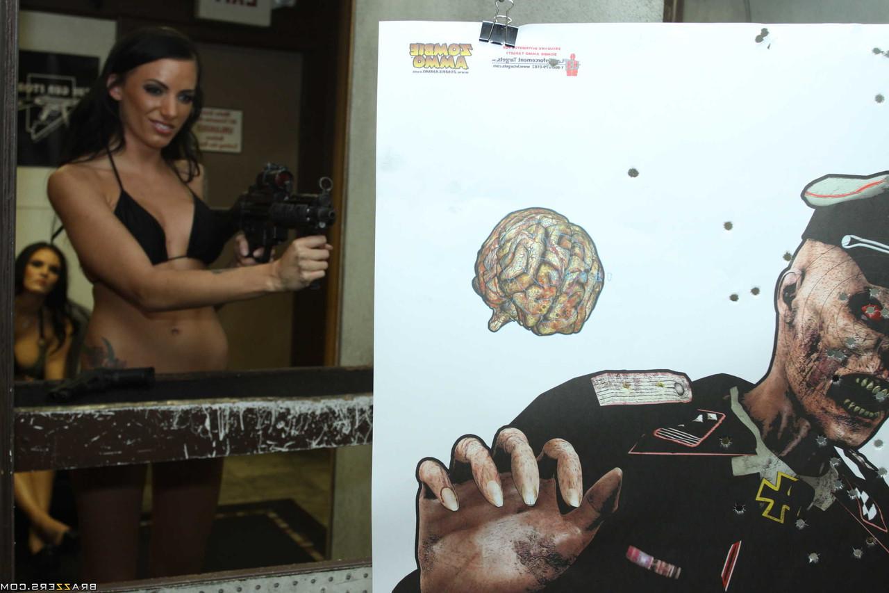 17P Tattooed brunette empties a few rounds at the shooting range in a bikini