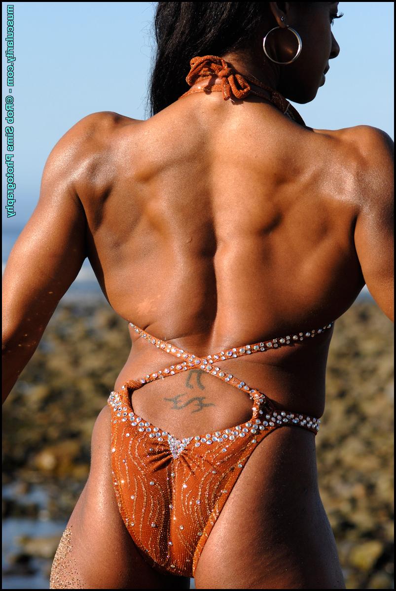 15P Black bodybuilder Stacy Simons flexes during a waterside solo shoot