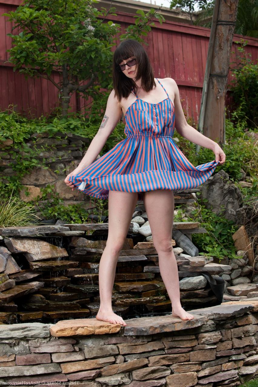 17P Vixen with sunglasses Thelma Sleaze fingers her fuzzy pussy in the garden