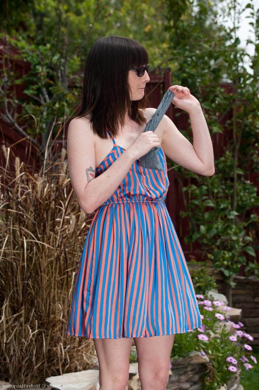 17P Vixen with sunglasses Thelma Sleaze fingers her fuzzy pussy in the garden