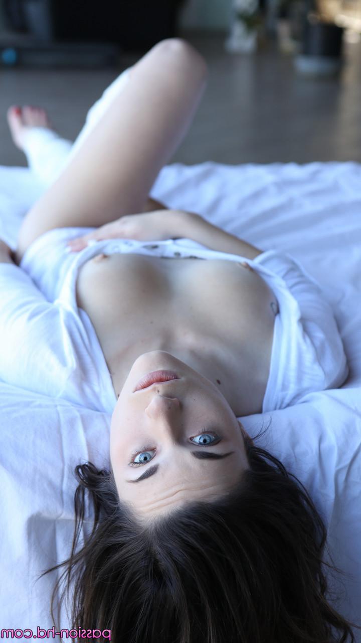 17P Raven haired model in white Lacey Channing loves to show off her body