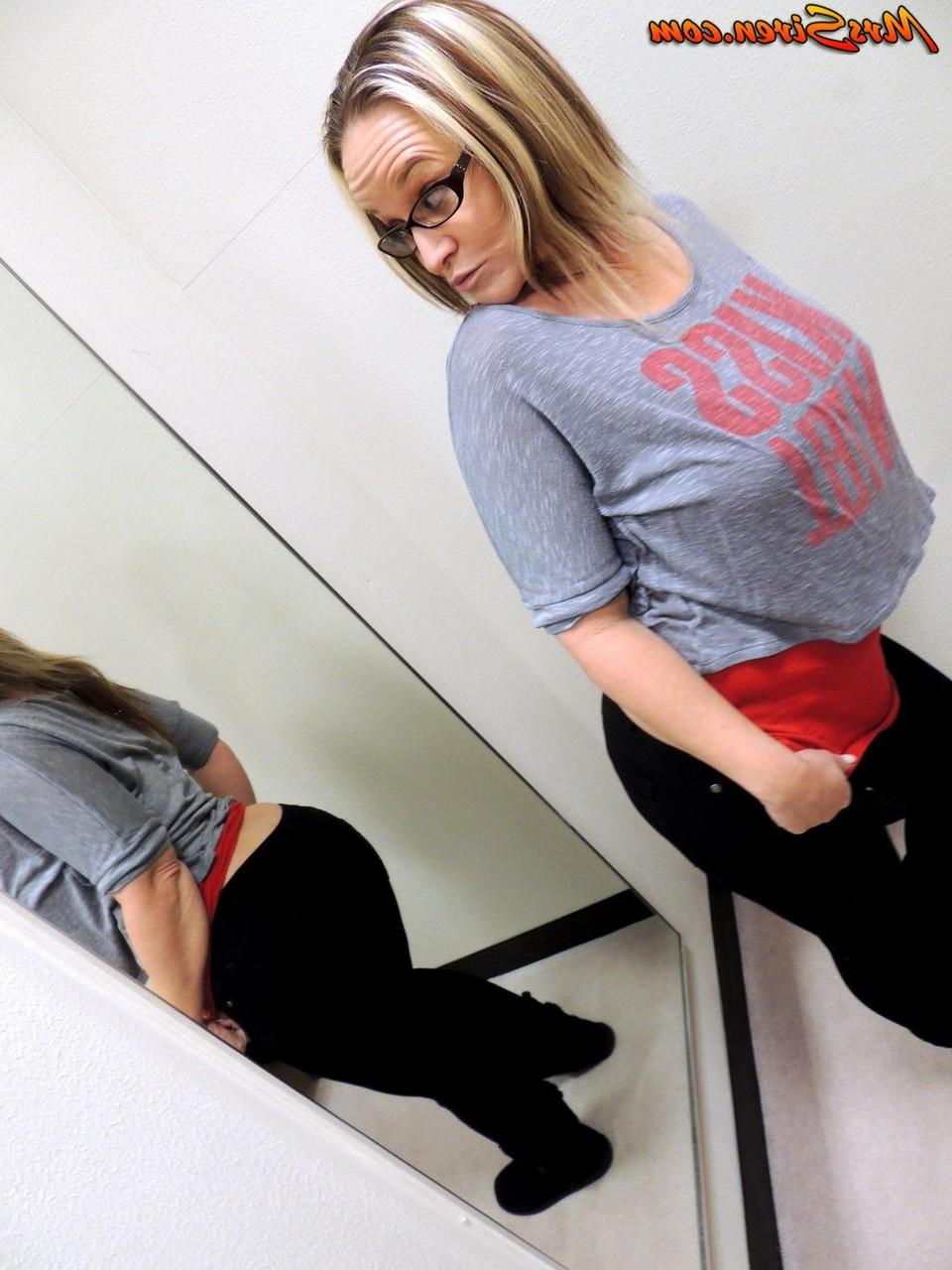 10P Amateur model Dee Siren admires her big butt in a wall mounted mirror