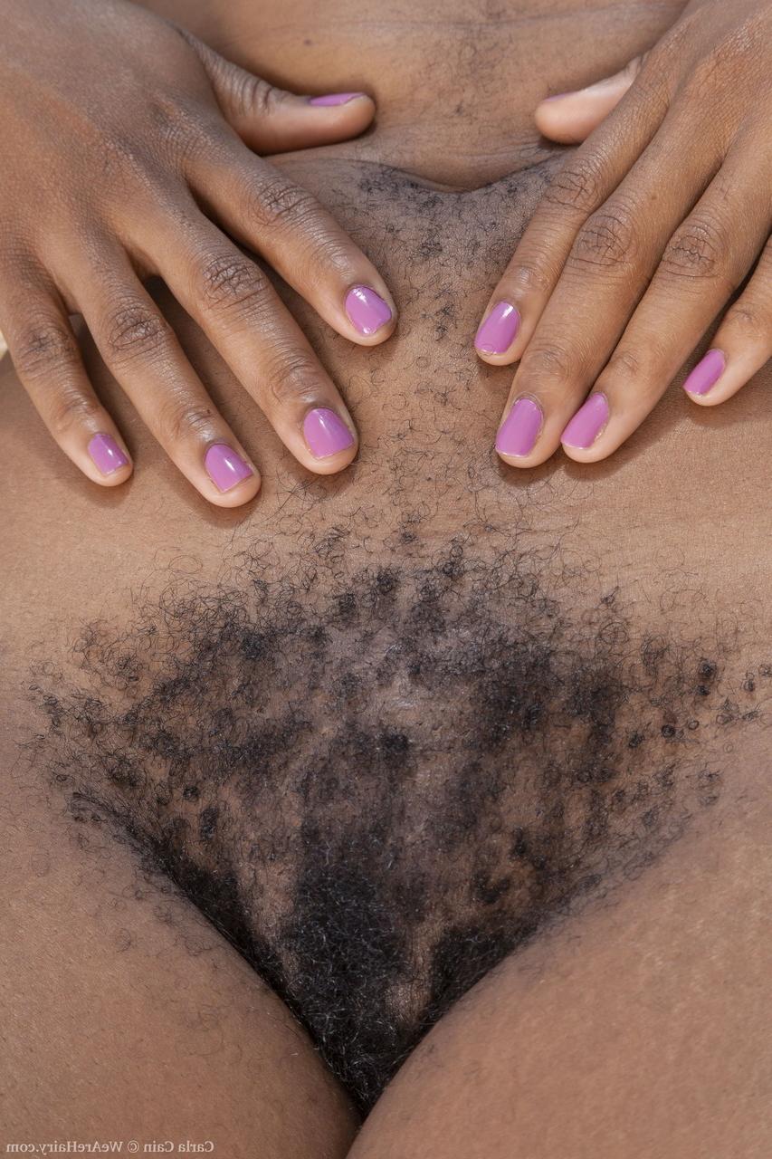 20P Ebony with dreads Carla Cain shows her big ass and hairy pussy in a solo