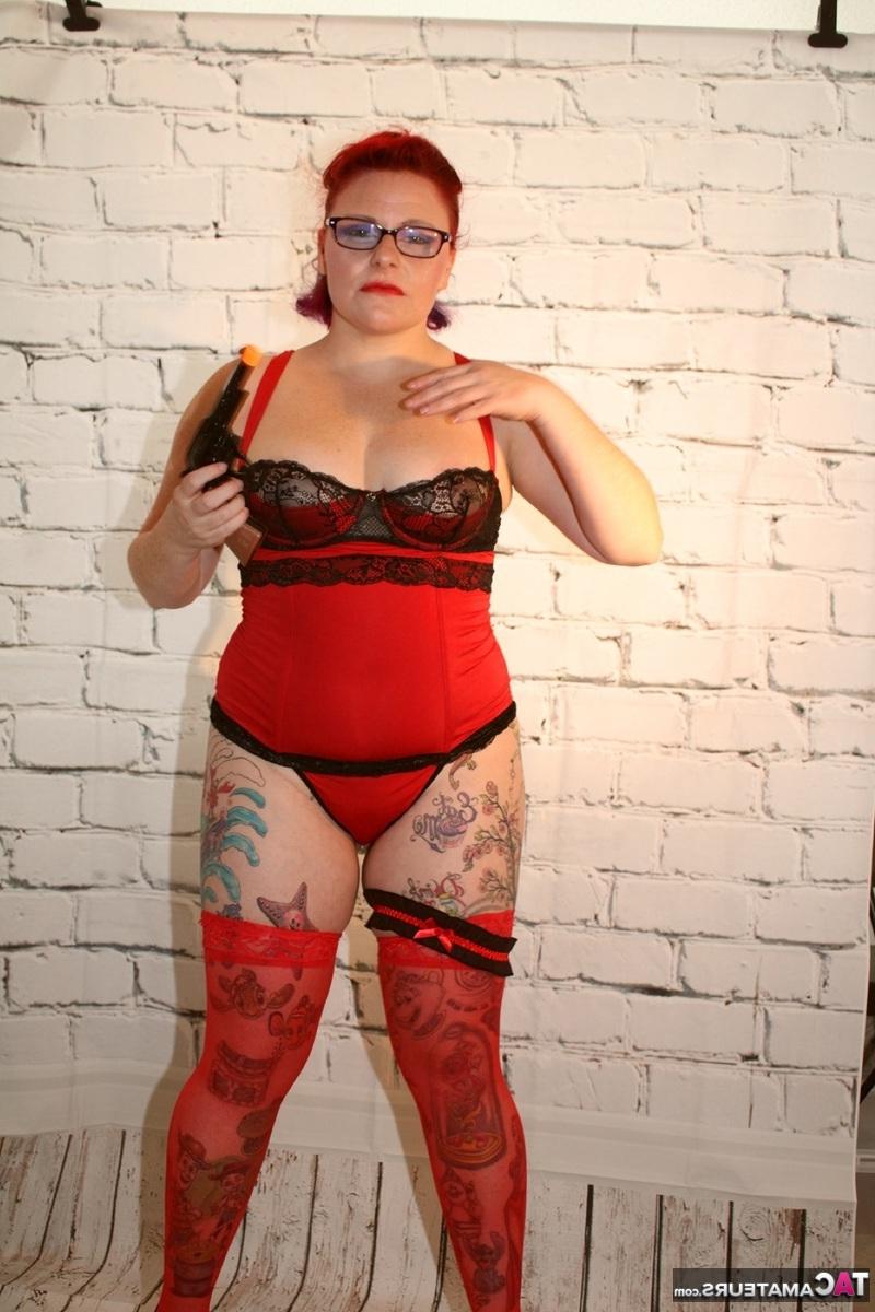 16P Older redhead pulls out a gun while wearing lingerie and stockings