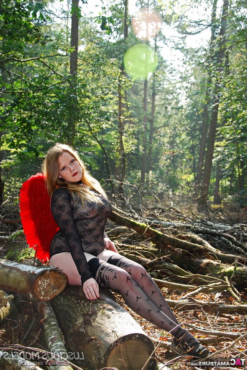 20P Amateur model poses in lingerie and stockings with angel wings in the woods