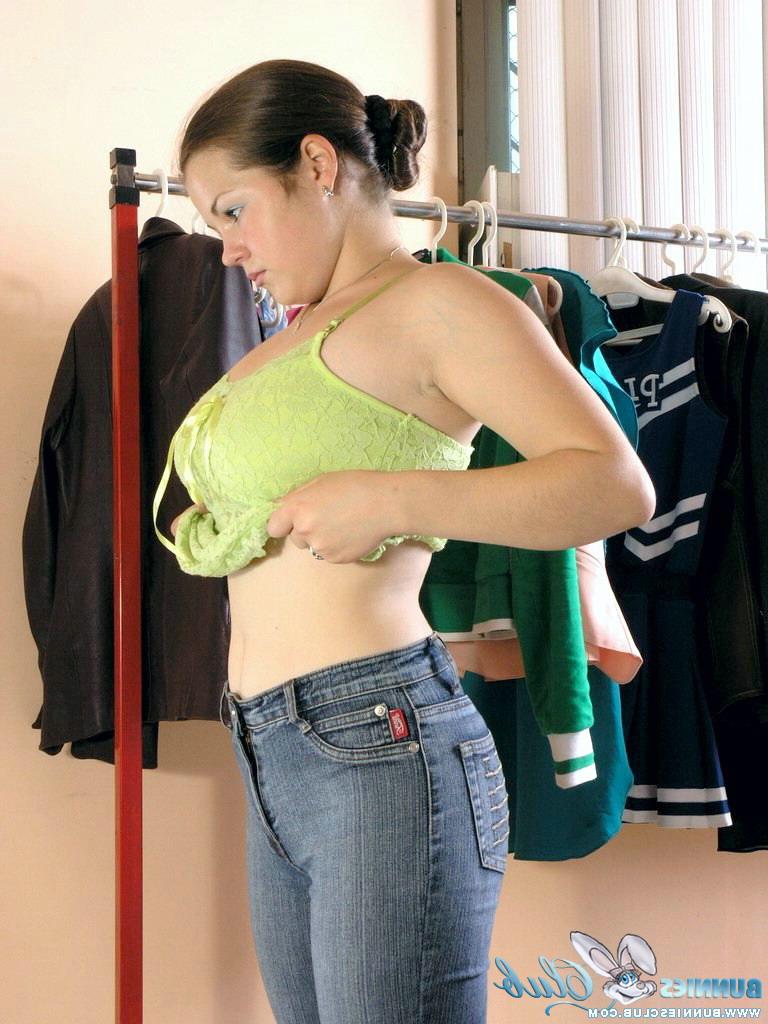 20P Young brunette Bea pulls on a pair of jeans after getting naked to change