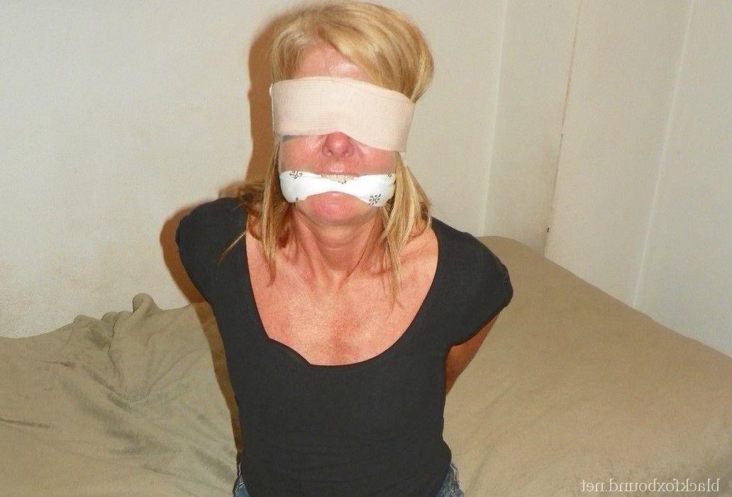 12P Clothed blonde is blindfolded and gagged while tied up at her hands and wrists