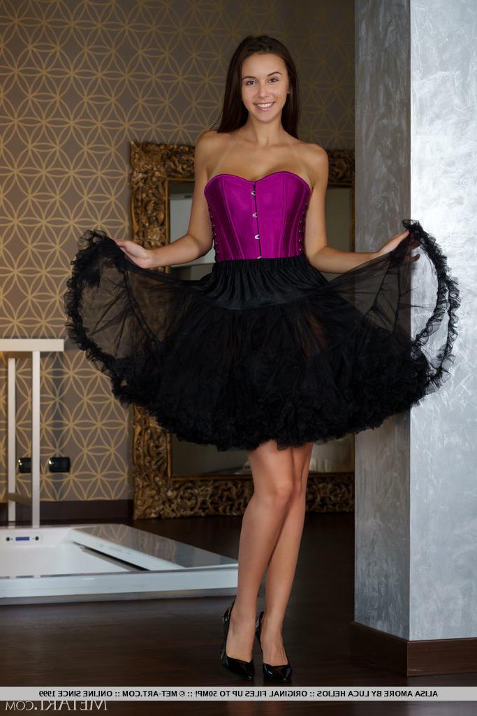 18P Brunette teen Alisa Amore doffs a corset and tutu skirt to model totally naked
