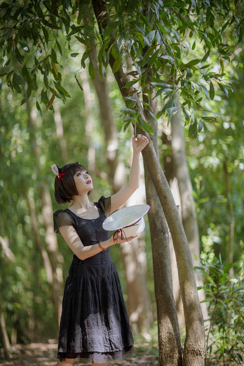 20P Pretty Asian model posing in her elegant black dress in the forest