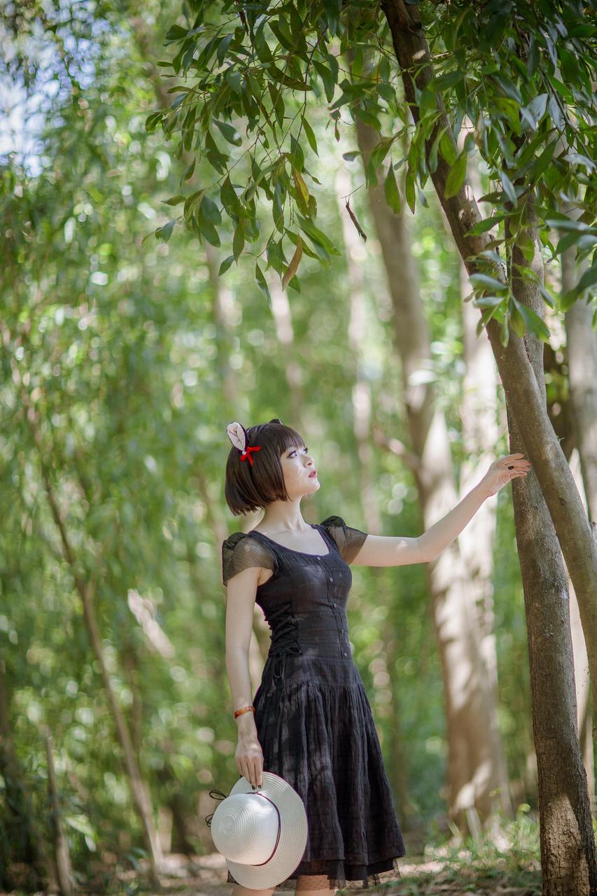 20P Pretty Asian model posing in her elegant black dress in the forest