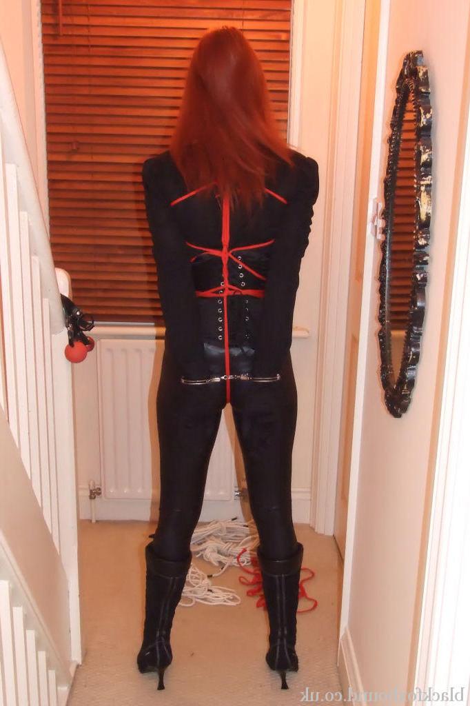 16P Fully clothed redhead sports a mask while gagged and bound as well