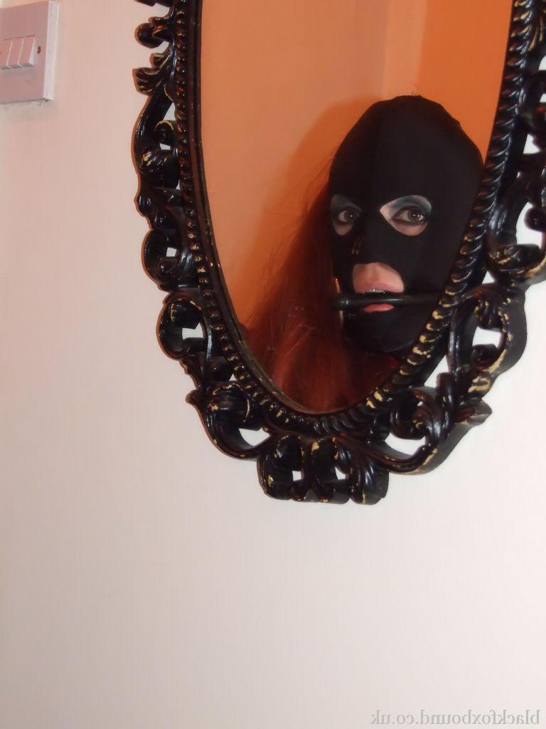 16P Fully clothed redhead sports a mask while gagged and bound as well