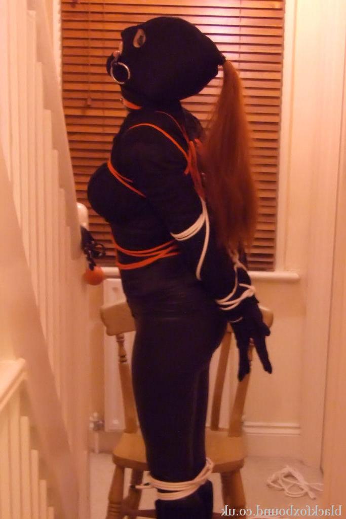 16P Fully clothed redhead sports a mask while gagged and bound as well