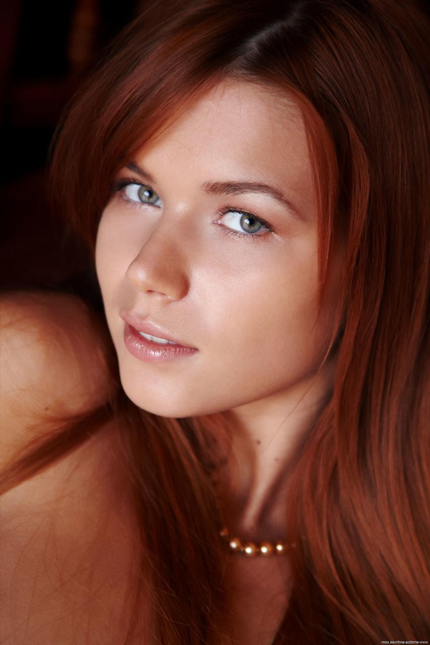17P Auburn-haired model with blue eyes Kami opens her legs widely on the armchair