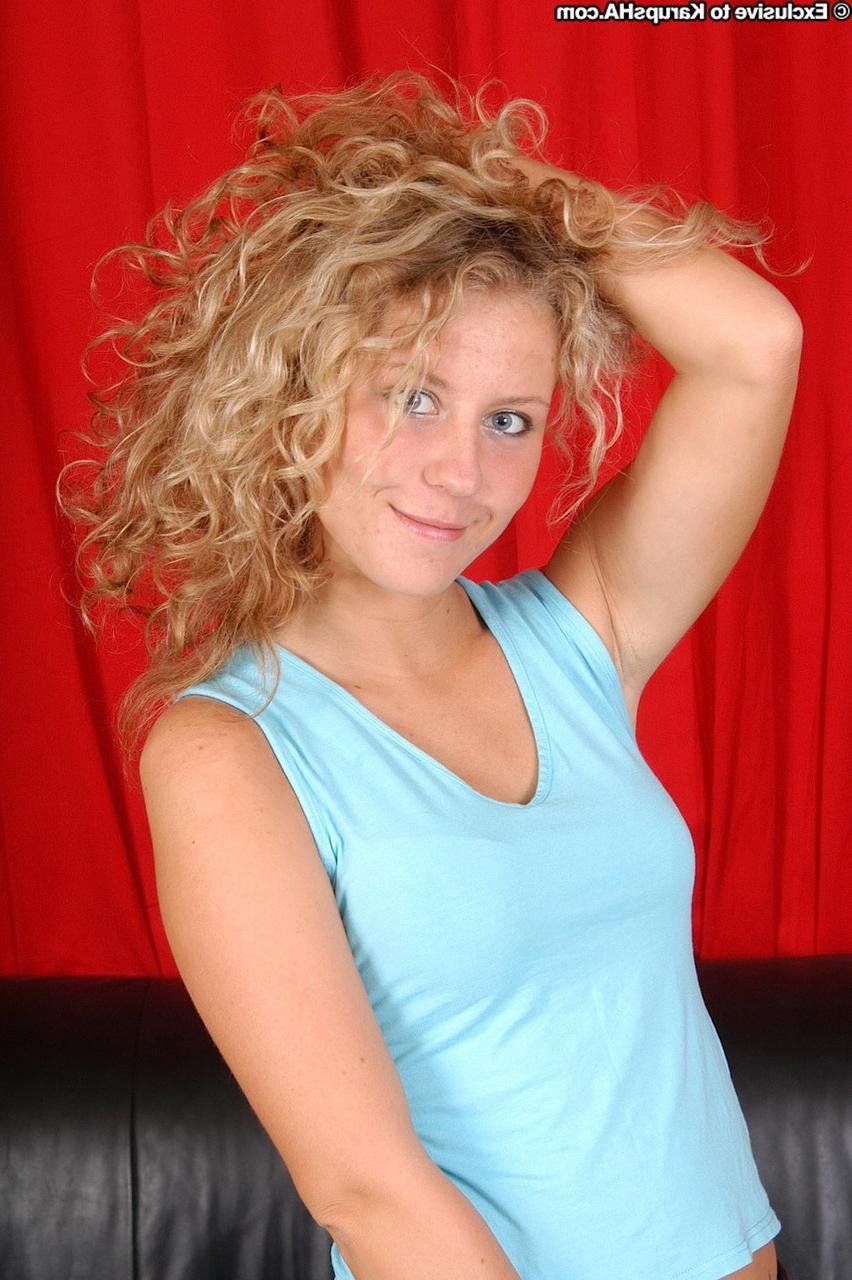 20P Curly haired blonde Lita exposes her tiny boobs and presents her cunt