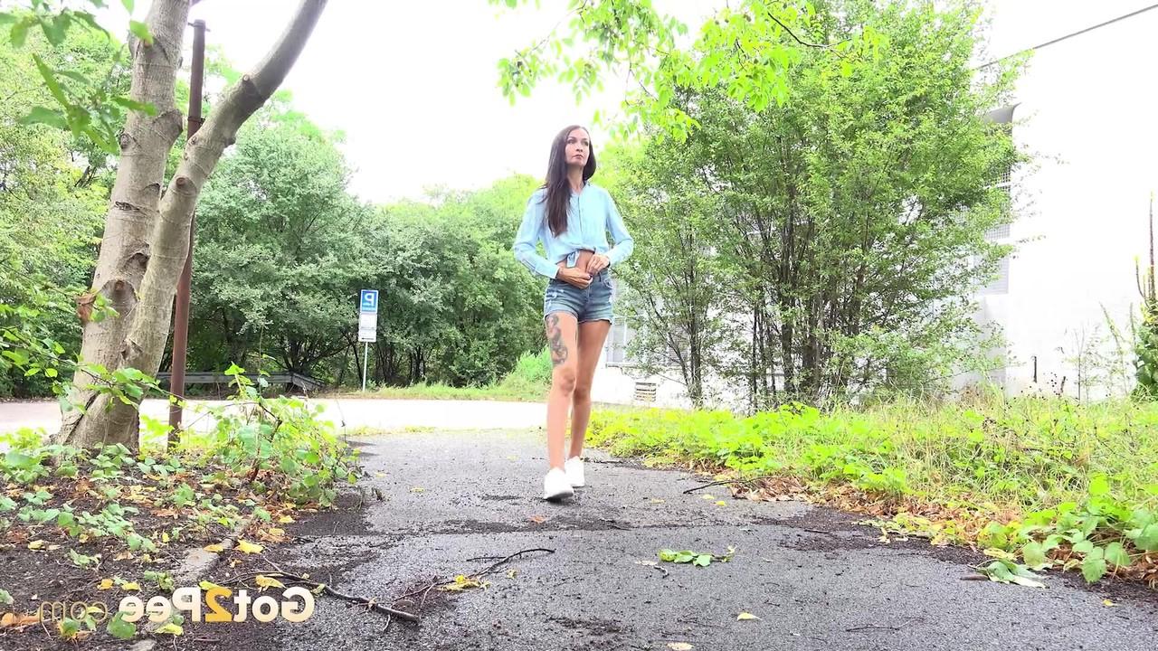 15P Skinny girl Mistica gets caught taking a piss on a paved path
