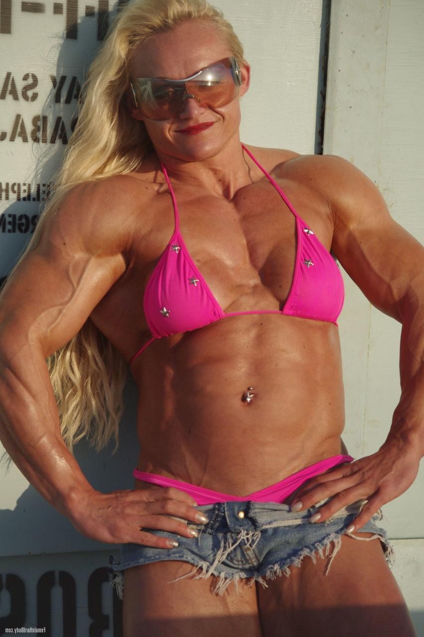 20P La bodybuilder perverse Brigita Brezovac exhibe ses muscles sur la plage.