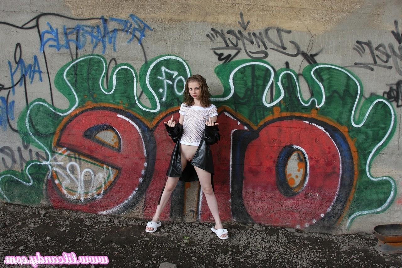 16P Sexy babe Lil Candy poses bottomless in her sheer top & leather jacket