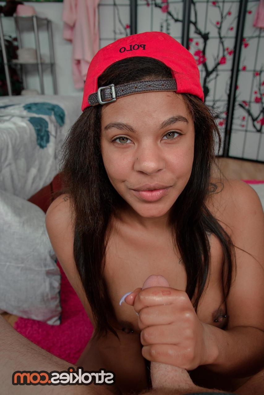 20P Young ebony Zoey Reyes eats a load of cum while giving a white cock a handjob
