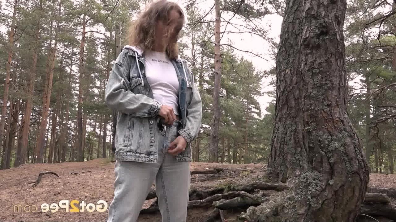 15P Beautiful girl Rita gets caught with her pants down while peeing in the woods