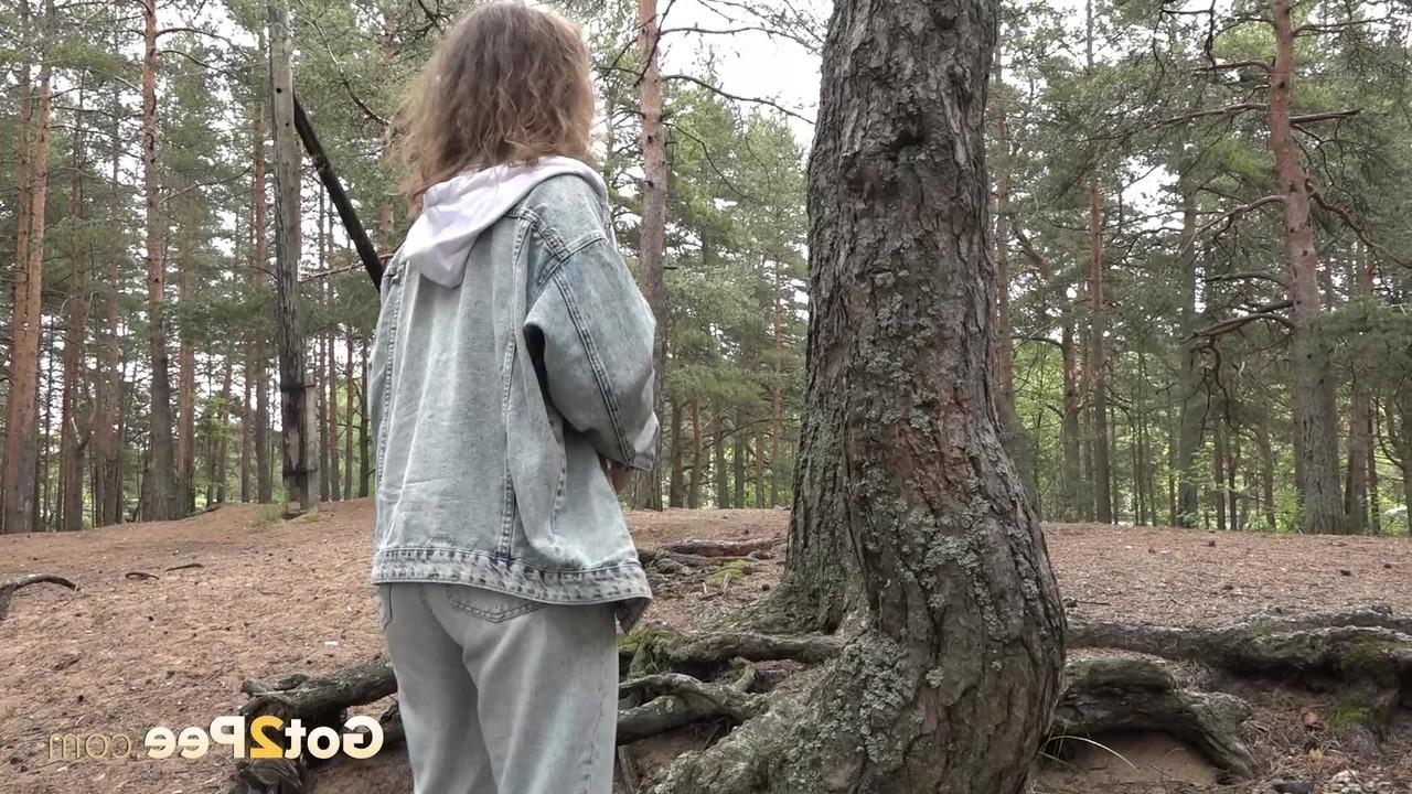 15P Beautiful girl Rita gets caught with her pants down while peeing in the woods
