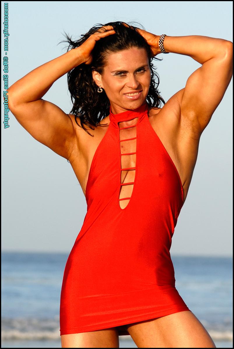 15P Dark-haired bodybuilder Lada Phihalova models a red dress at the beach