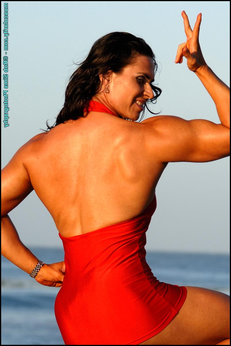 15P Dark-haired bodybuilder Lada Phihalova models a red dress at the beach