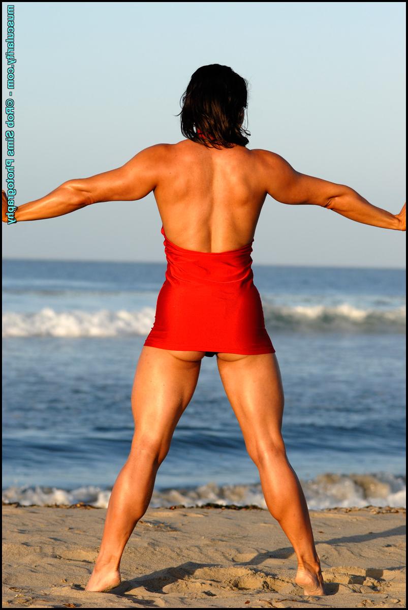 15P Dark-haired bodybuilder Lada Phihalova models a red dress at the beach