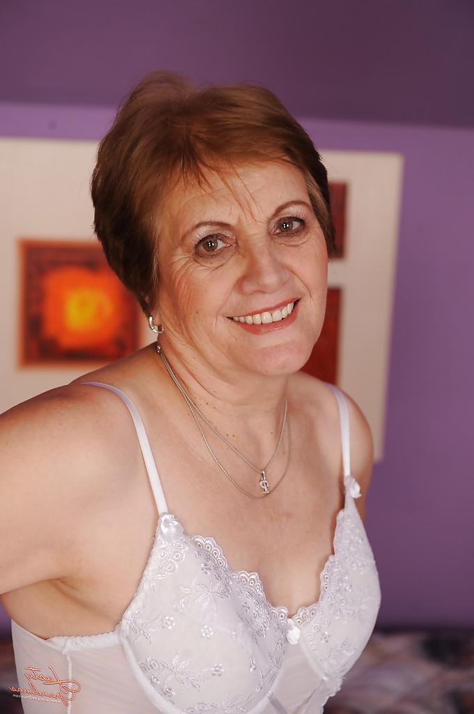 14P Naughty granny with hairy twat taking off her lingerie and spreading her legs