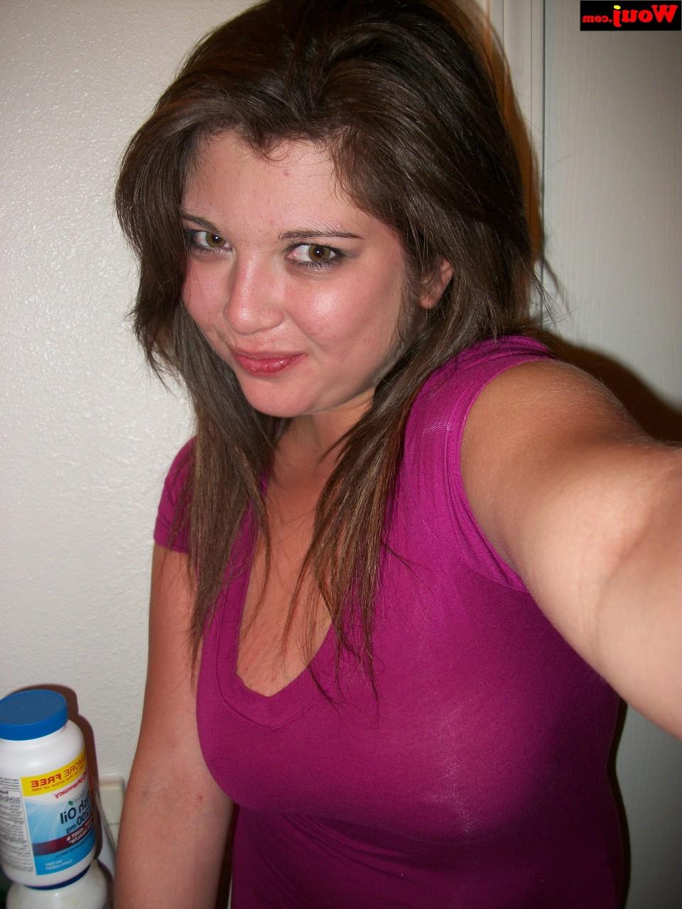 15P Brunette amateur WouJ flaunts her cleavage wearing a shiny pink dress