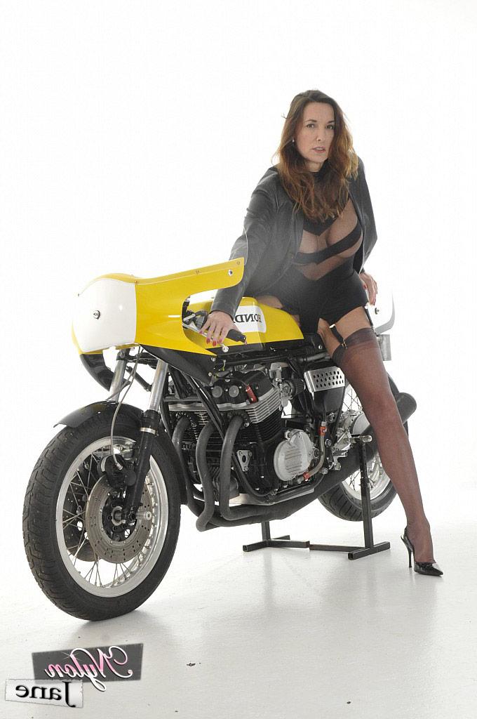 15P Older woman Nylon Jane models on a motorcycle in nylons and garters