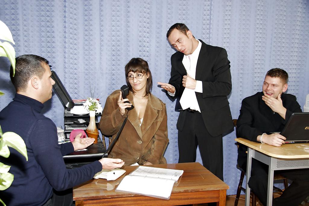 16P Hot brunette in glasses is being humped in office by clothed guys