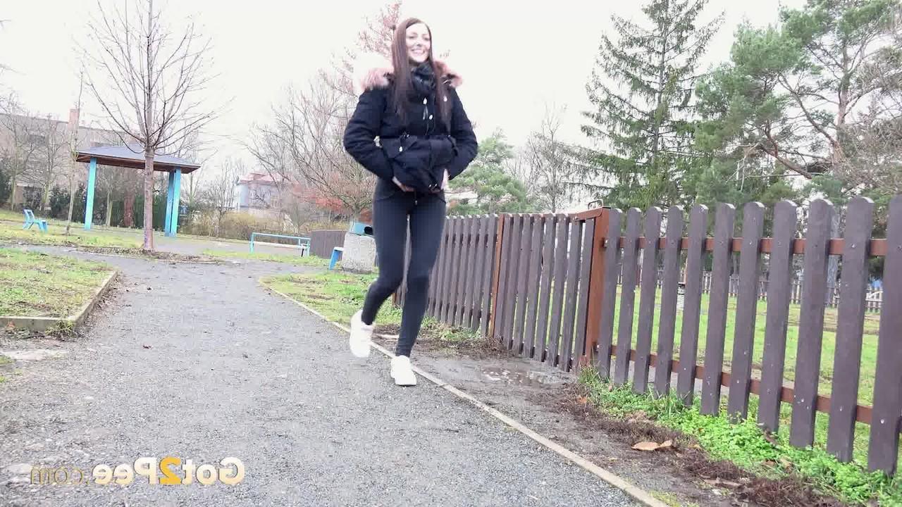 15P Caucasian girl Katy Sky ducks behind a picket fence for a badly needed pee