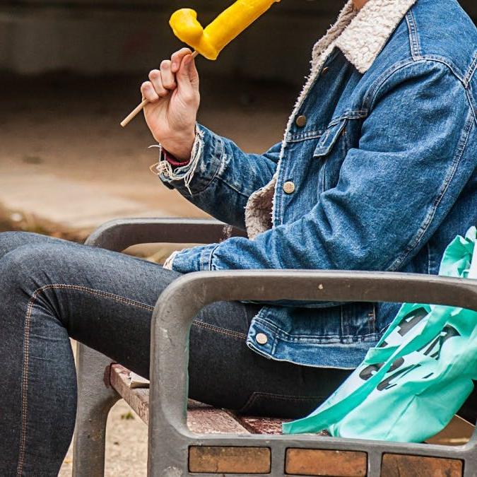 12P Gay brunette Victor A erotically sucks a sex toy lollipop on a public bench